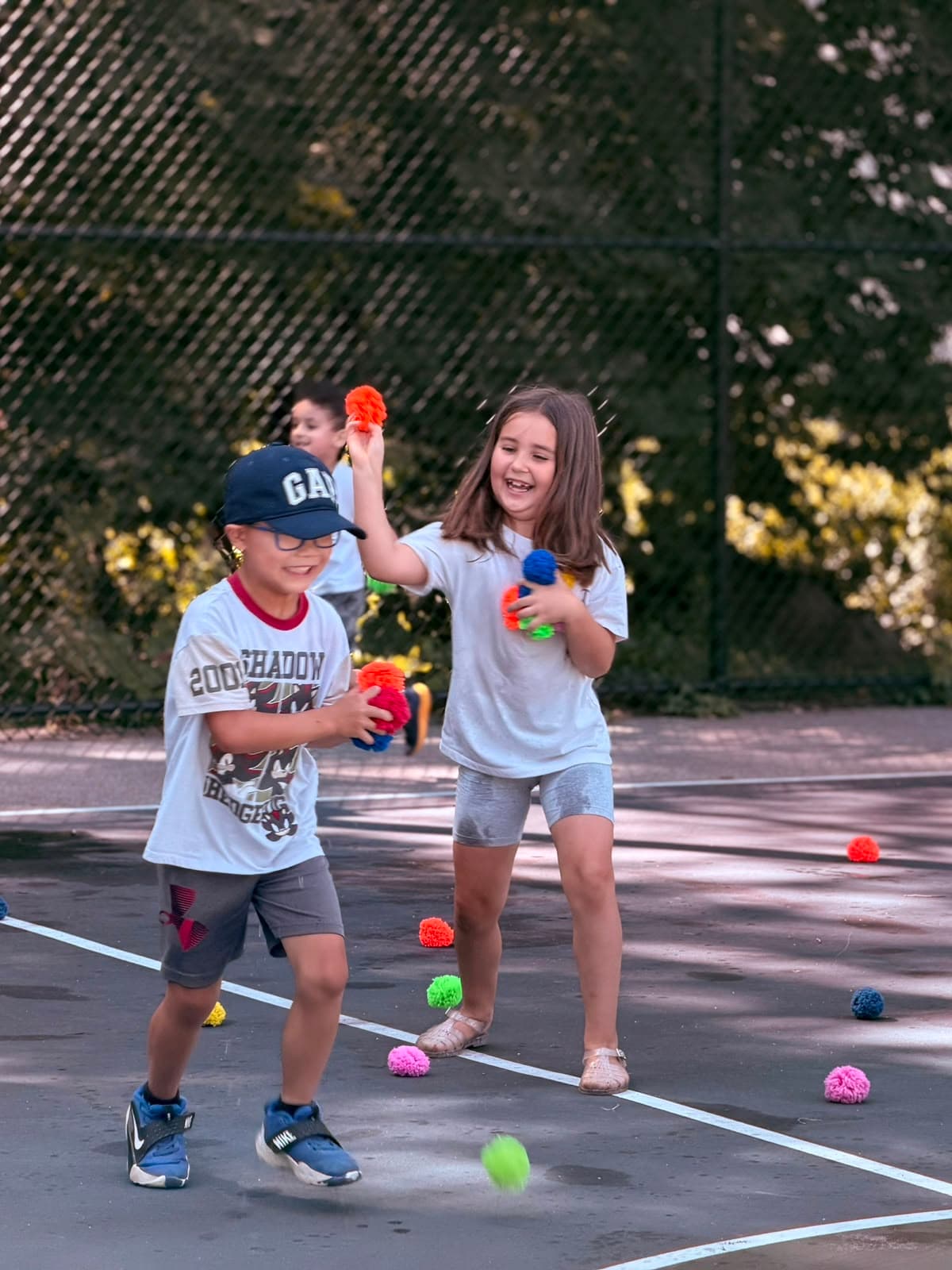 Children laughing and playing an active group game at GCS