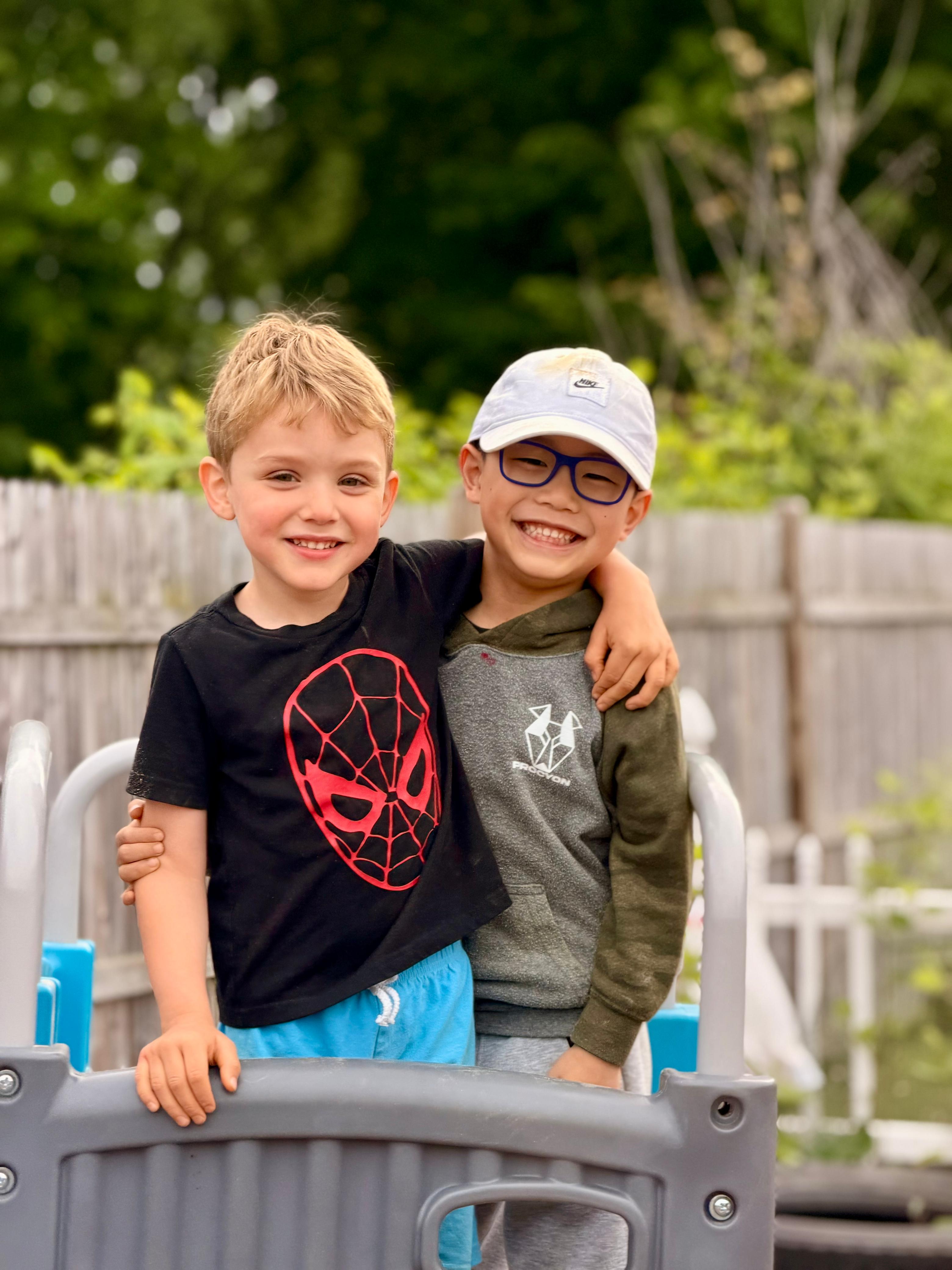 Two Global Children School friends standing together outdoors