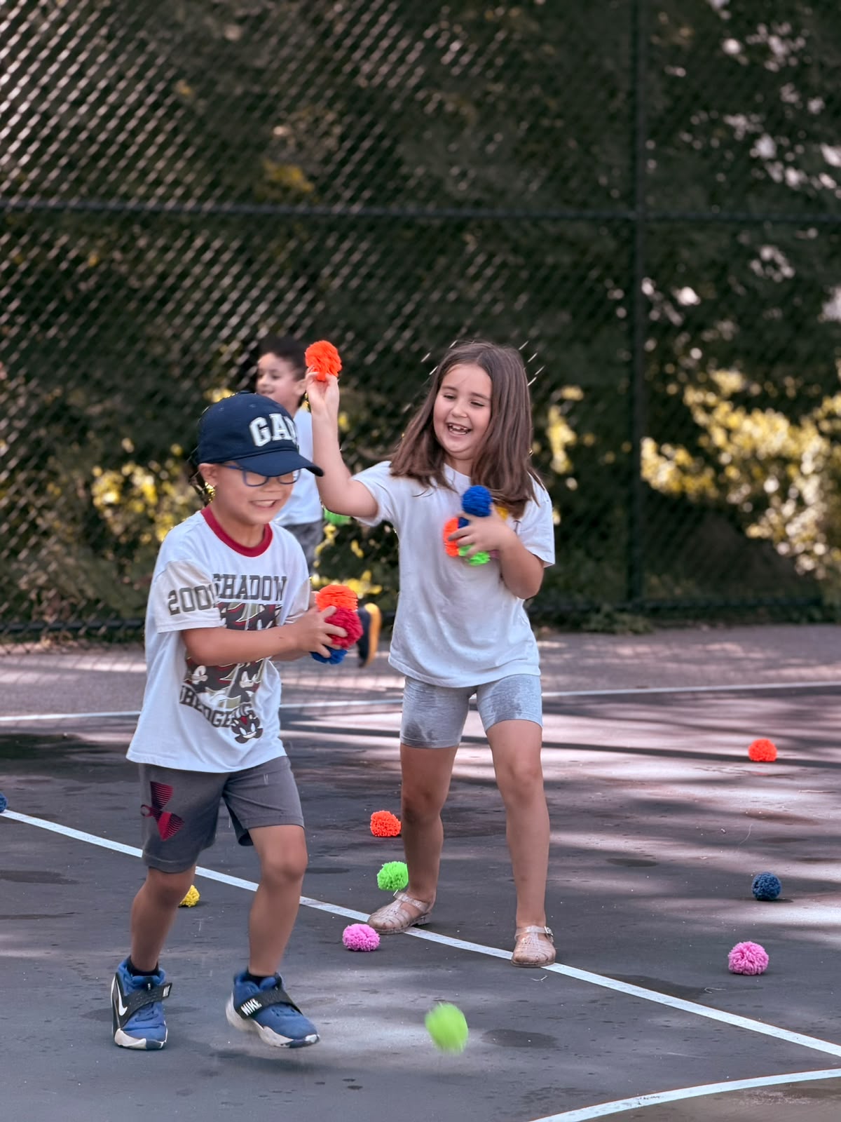 GCS children laughing together during an outdoor game