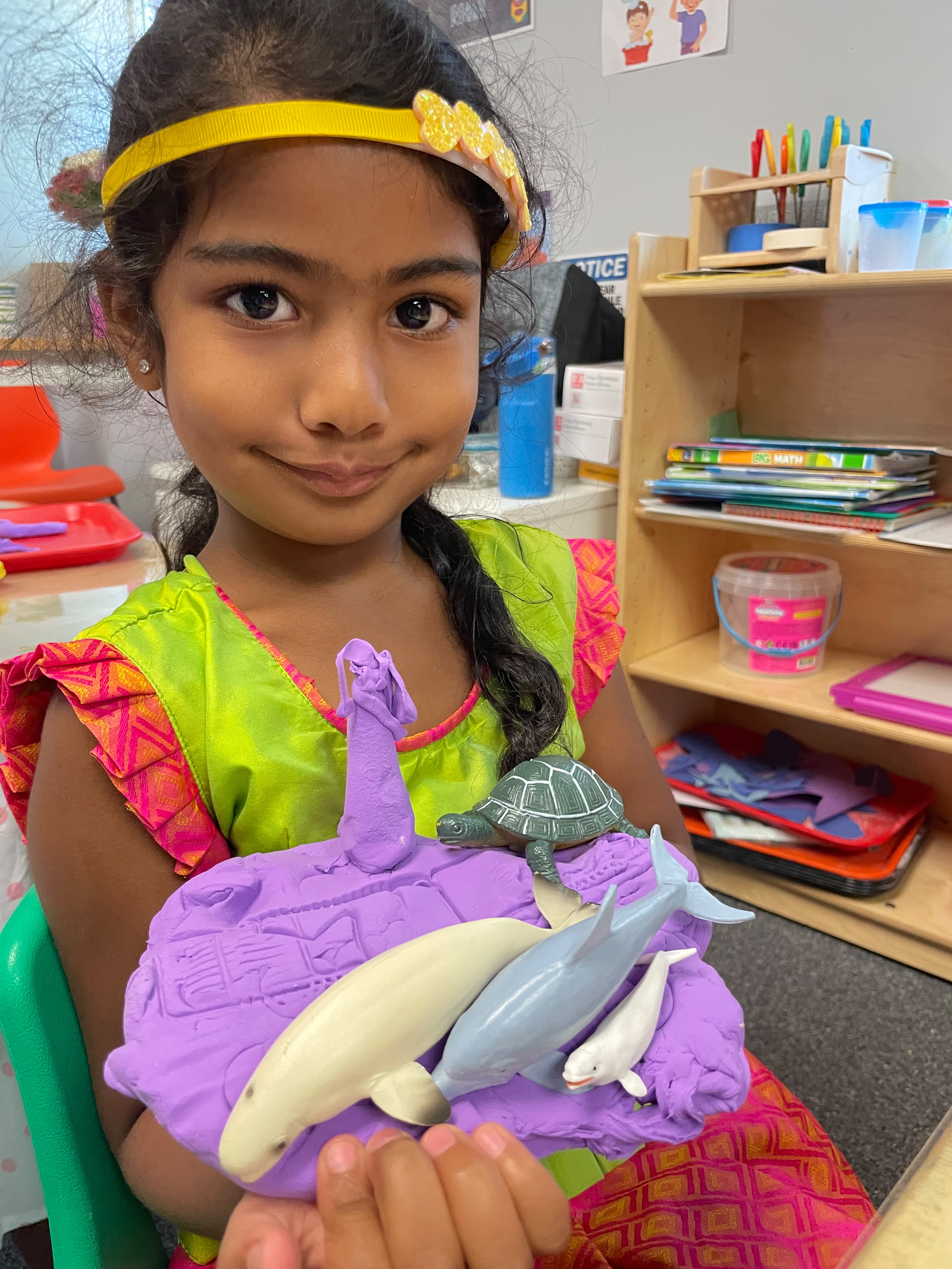 A GCS student smiling with her ocean learning project