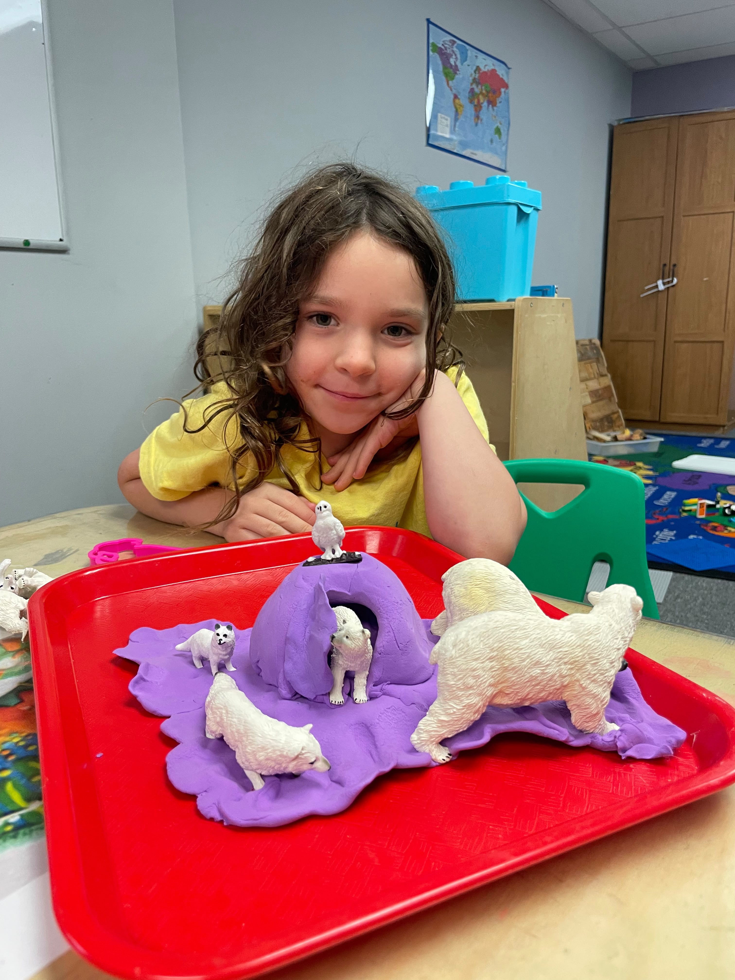 A GCS student proudly sharing a polar habitat project